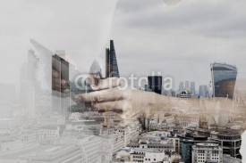 Double exposure of success businessman using digital tablet with