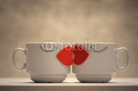 Naklejki Two coffee cups with red hearts as a kissing lips