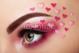 Eye make-up girl with a heart. Valentine's day makeup. Beauty fashion. Eyelashes. Cosmetic Eyeshadow. Makeup detail. Creative woman holiday make-up