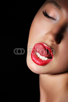 Carnality. Lust. Woman Licking her Red Sexy Lips. Passion