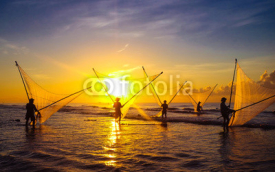 Fototapety Fishermen fishing in the sea at sunrise in Namdinh, Vietnam