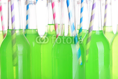 Bottles of drink with straw close up