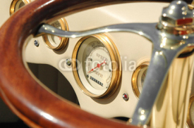 Obrazy i plakaty speedometer dial and steering wheel on a retro auto