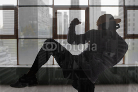 Fototapety Man with headphones training on the background of window