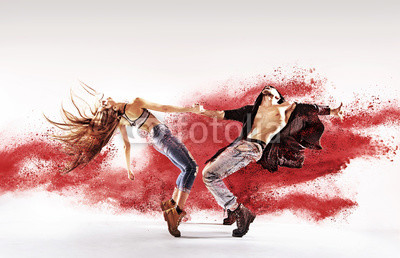 Talented young dancers sprinkling red dust