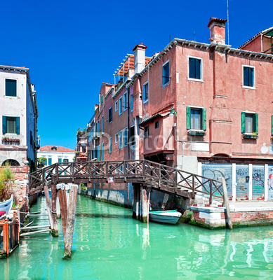Colored Venice canal with bridge and houses in water, Italy