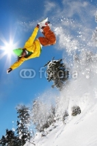 Fototapety Snowboarder jumping against blue sky