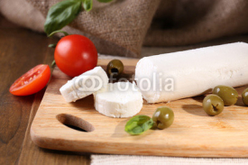 Fototapety Tasty bushe cheese with tomatoes, olives and basil,