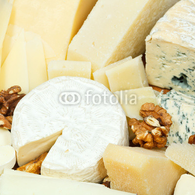 various sliced cheeses and walnuts