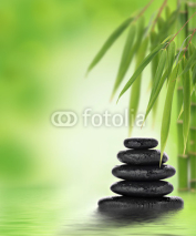 Fototapety Tranquil zen design with stacked massage stones and bamboo