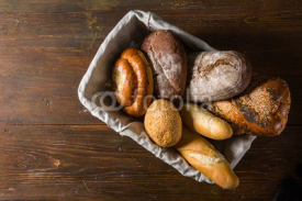 Naklejki Photo of the assorted bread in wooden basket