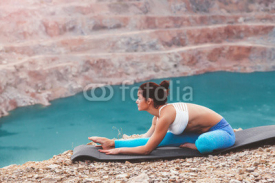 Naklejki Girl training yoga pose outdoor