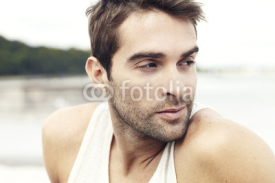 Fototapety Handsome man sitting outdoors