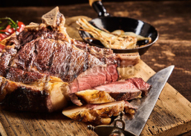 Fototapety Close up on rare cooked cote de boeuf steak with knife