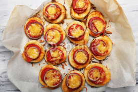 Naklejki Small pizzas on baking paper close up