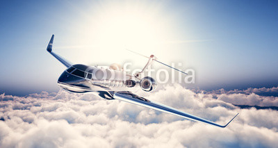 Photo of black luxury generic design private jet flying in blue sky. Huge white clouds and sun at background. Business travel concept. Horizontal. 3d rendering
