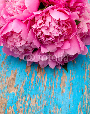 bunch of peonies on wooden surface