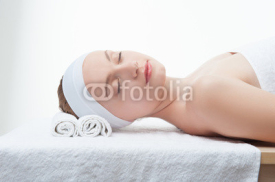 Naklejki Young beautiful woman in spa relaxing on massage table