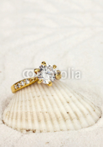 Fototapety macro photo of jewelry ring with big diamond on white sand backg