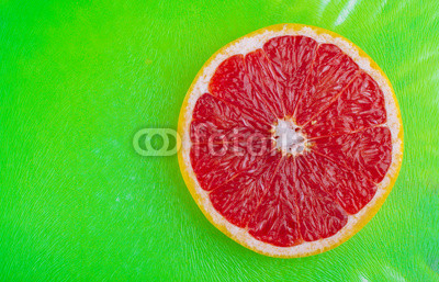 Fresh Grapefruit on green background and high contrast