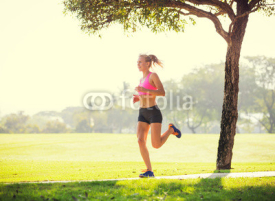 Naklejki Young woman jogging running outdoors
