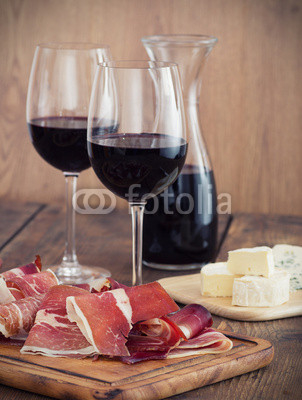 sliced prosciutto with red wine and olives