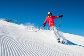 Naklejki Woman skiing in high mountains - modified piste
