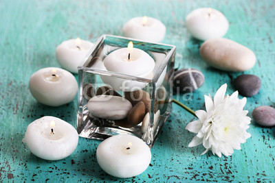 Decorative vase with candles, water and stones