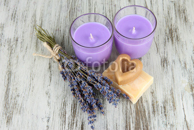 Lavender candle with fresh lavender, soap on wooden background