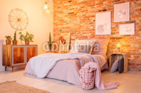 Warm bedroom with brick wall