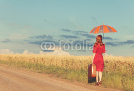 Naklejki Redhead girl with umbrella and suitcase at outdoor