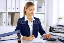 Modern business woman or confident female accountant in office