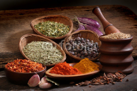 Fototapety Different spices over a wood background.