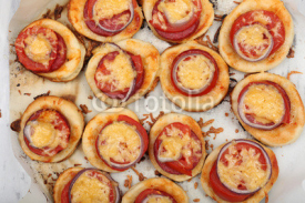 Fototapety Small pizzas on baking paper close up