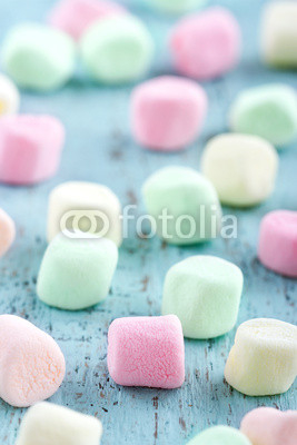 Colorful small marshmallows on wooden background