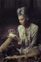 Fototapety Sad woman holding candle