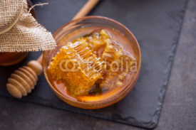 healthy honeycomb in the honey on the table.