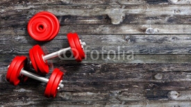 Naklejki 3D rendering of adjustable metallic red dumbbells, on wooden background with copy-space