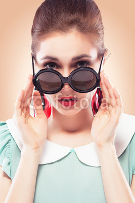 Surprised girl in round sunglasses