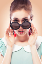 Naklejki Surprised girl in round sunglasses