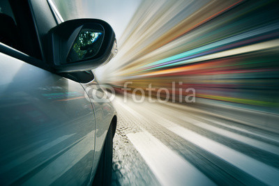 Car driving in city, blurred motion background.