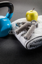 Obrazy i plakaty exercise and diet, apple and kettle bell on gym mat