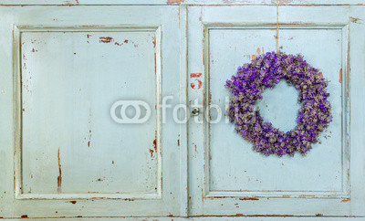 Lavender flower wreath hanging on an old door