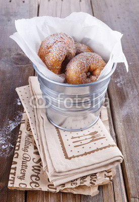 Cinnamon doughnuts in a metal bucket