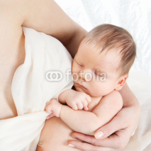 Naklejki Newborn baby lying on hands of his mother