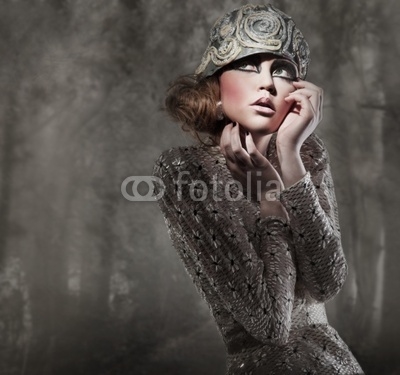 beautiful young lady in a mysterious gray forest