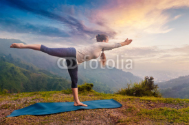 Fototapety Woman doing Ashtanga Vinyasa Yoga asana Virabhadrasana 3 Warrior