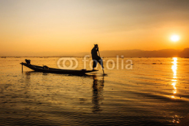 Naklejki A local fisherman is travelling by boat, Inle lake, Myanmar.