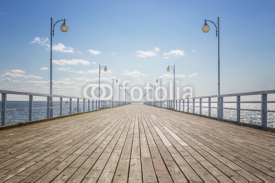 Fototapety Old empty wooden pier over the sea shore with copy space