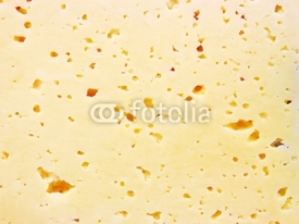 Naklejki Background of fresh yellow Swiss cheese with holes